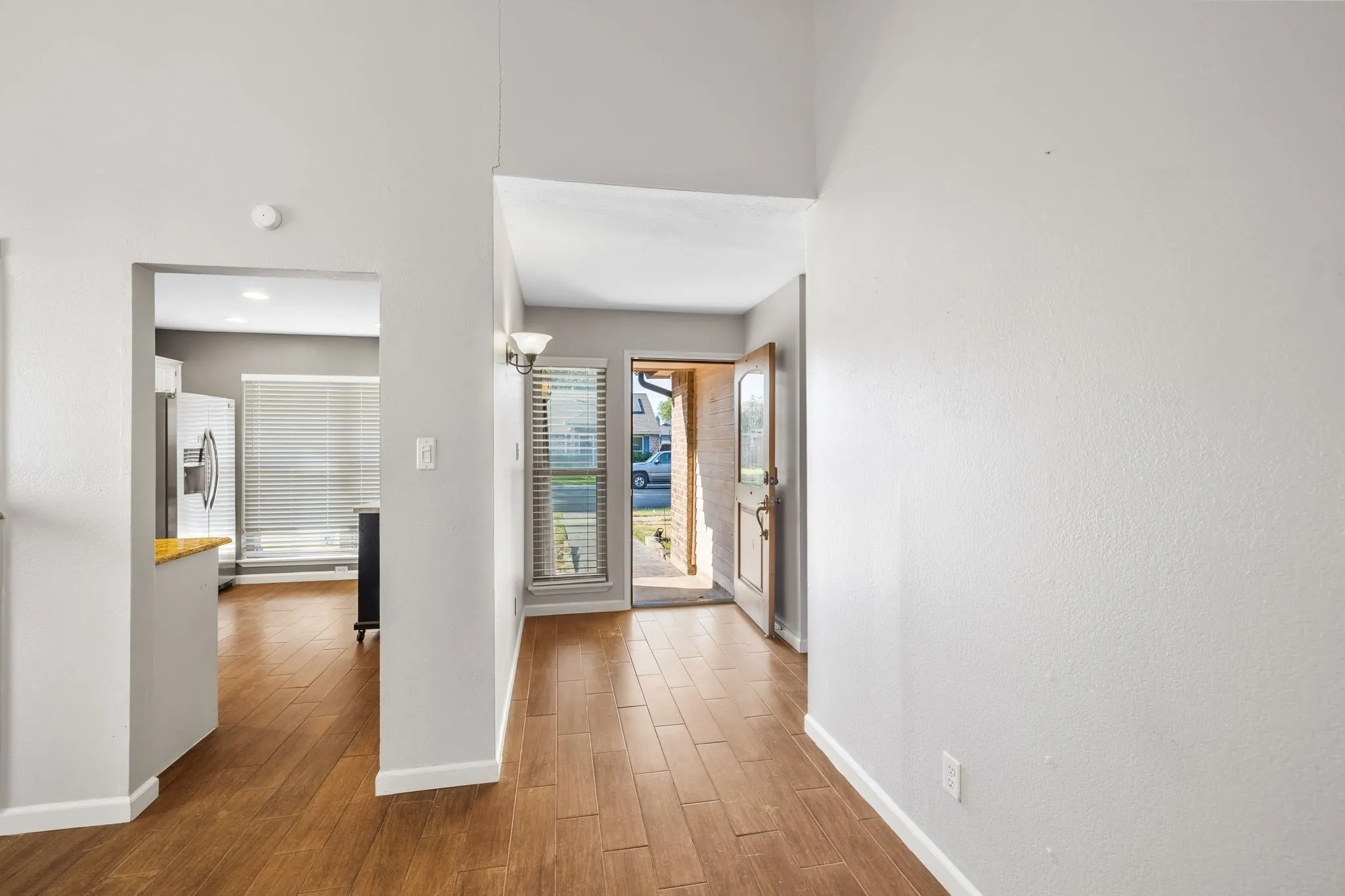 View from the living room toward the kitchen and front entry.