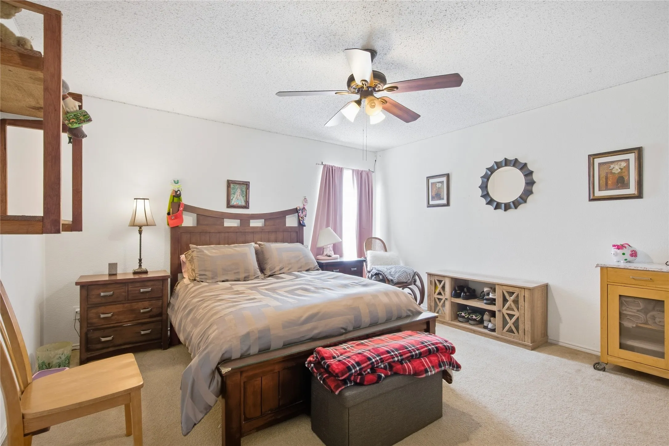 Spacious room featuring neutral carpeting and white walls