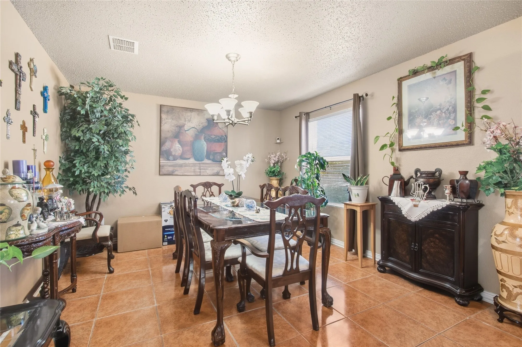 Tile flooring throughout, neutral wall color, window with privacy blinds, and a multi-light ceiling fixture