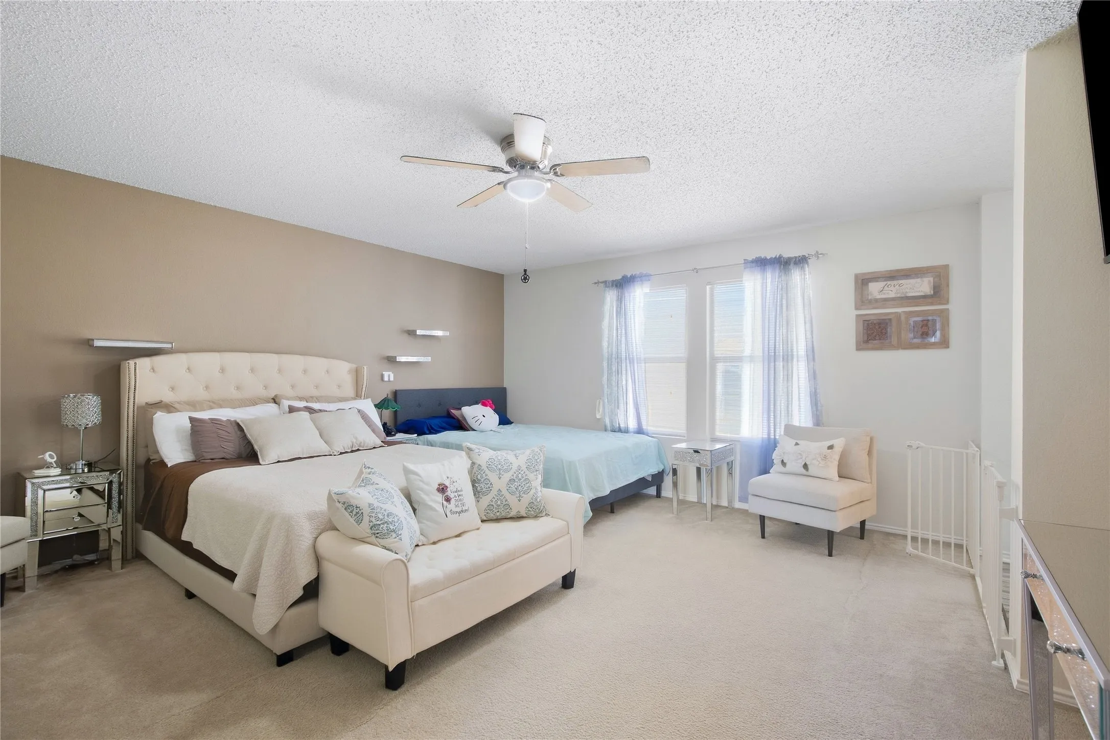 Recessed ceiling lighting, ceiling fan, and multiple windows with vertical blinds