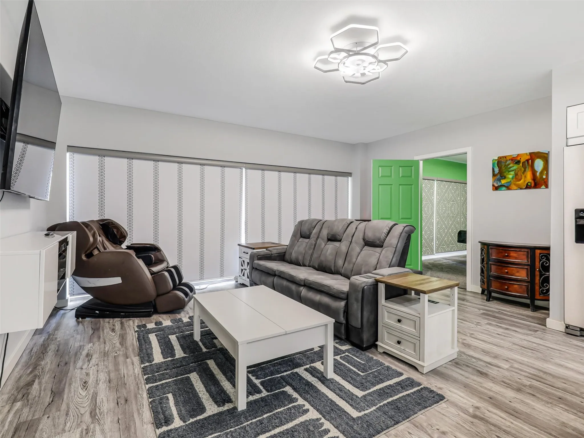 View from the 1st primary suite through the living / dining area to the 2nd primary suite in this split floor plan layout design.