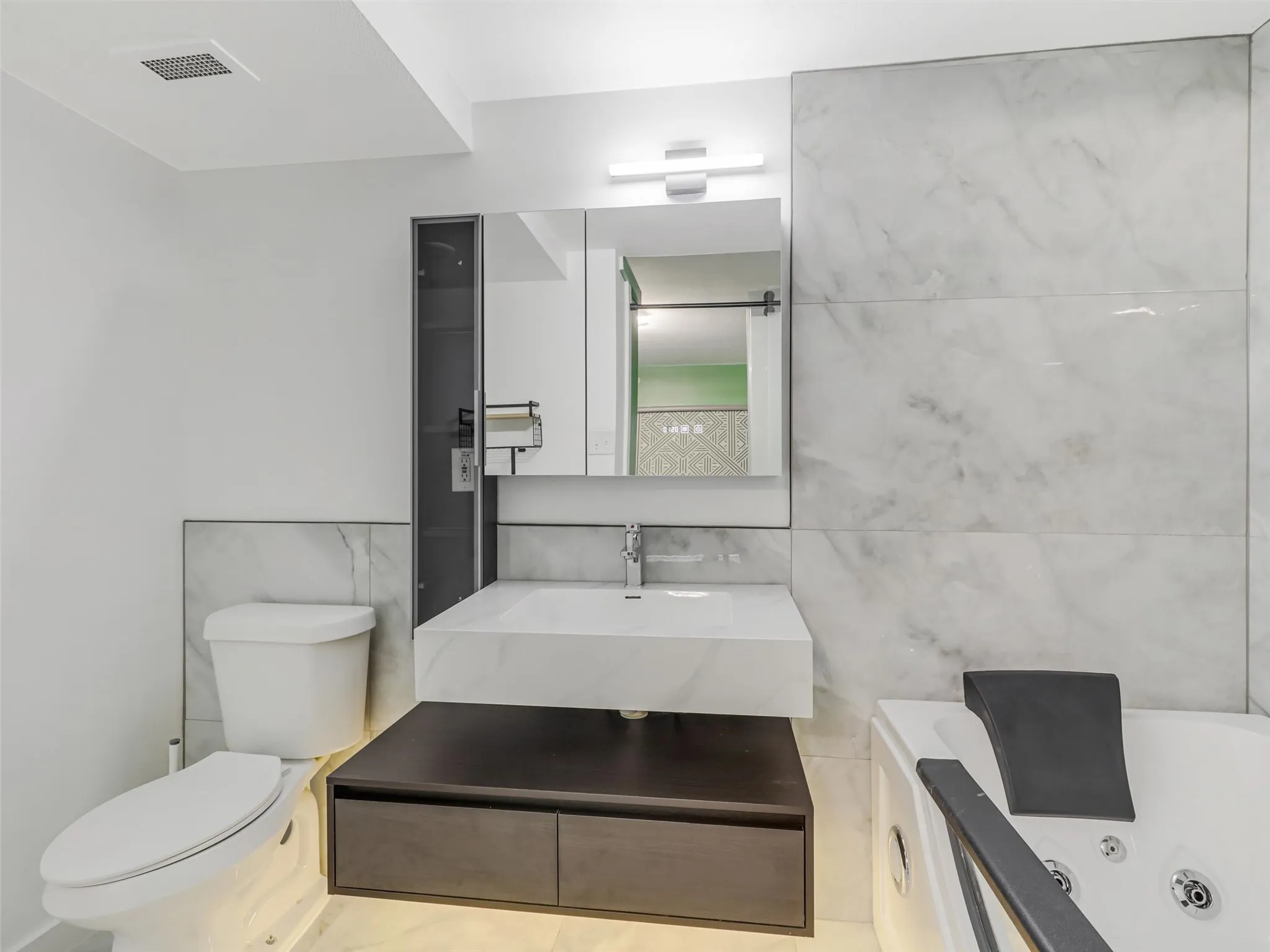 Second primary bathroom - recently updated with floating vanity and jetted tub