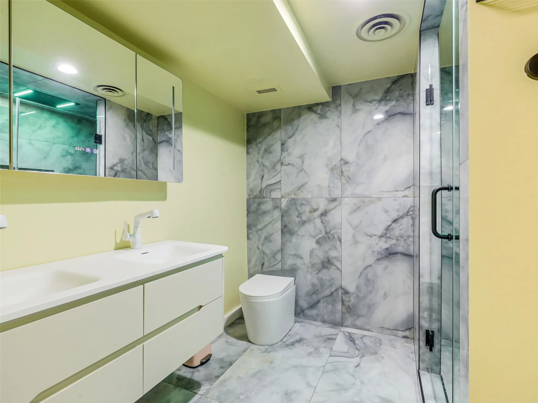 Recently updated first primary bath shower tile, rainflow shower head, floating vanity & Dubai toilet.