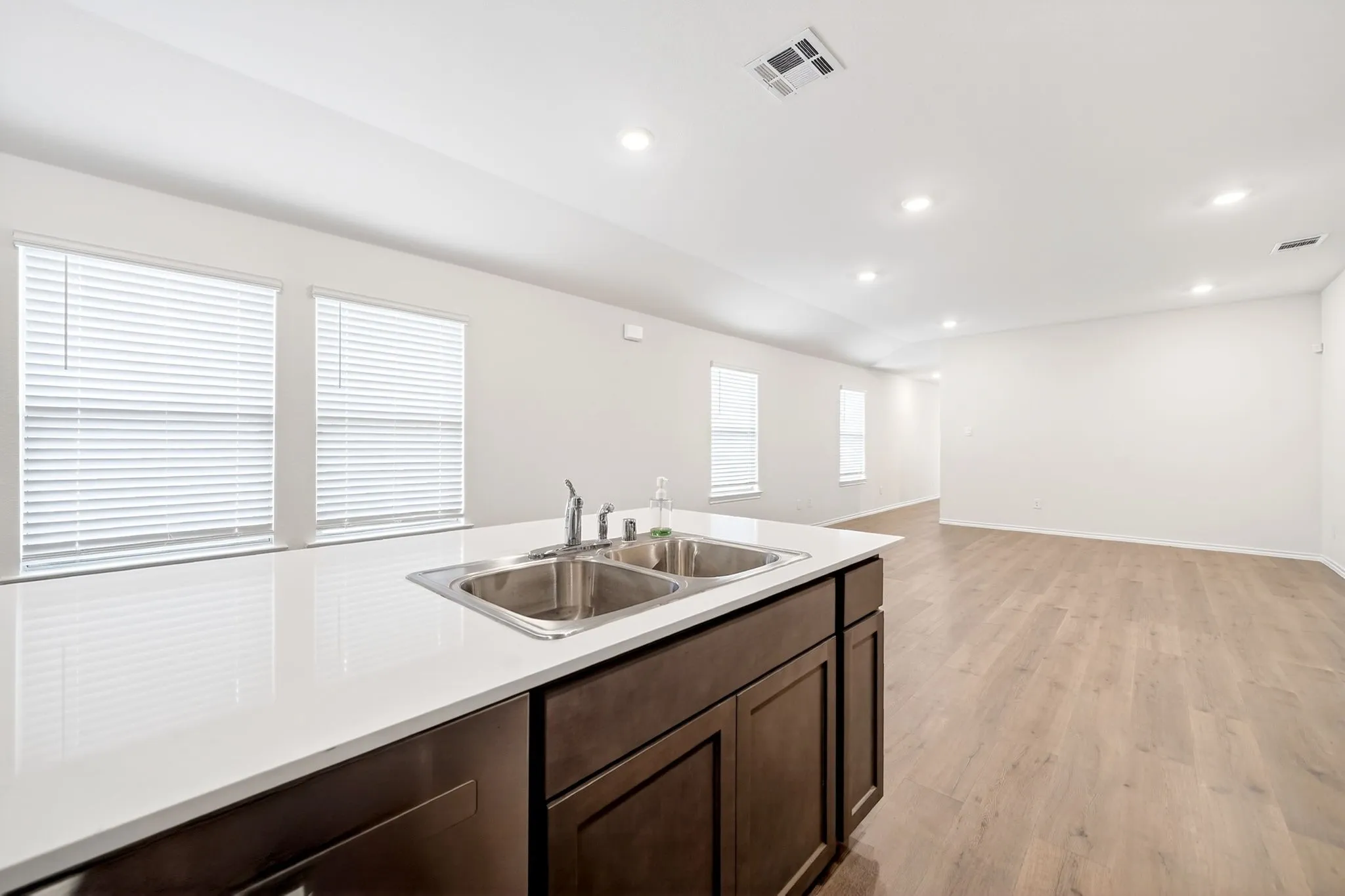 Kitchen island with a double basin stainless steel sink and a white countertop