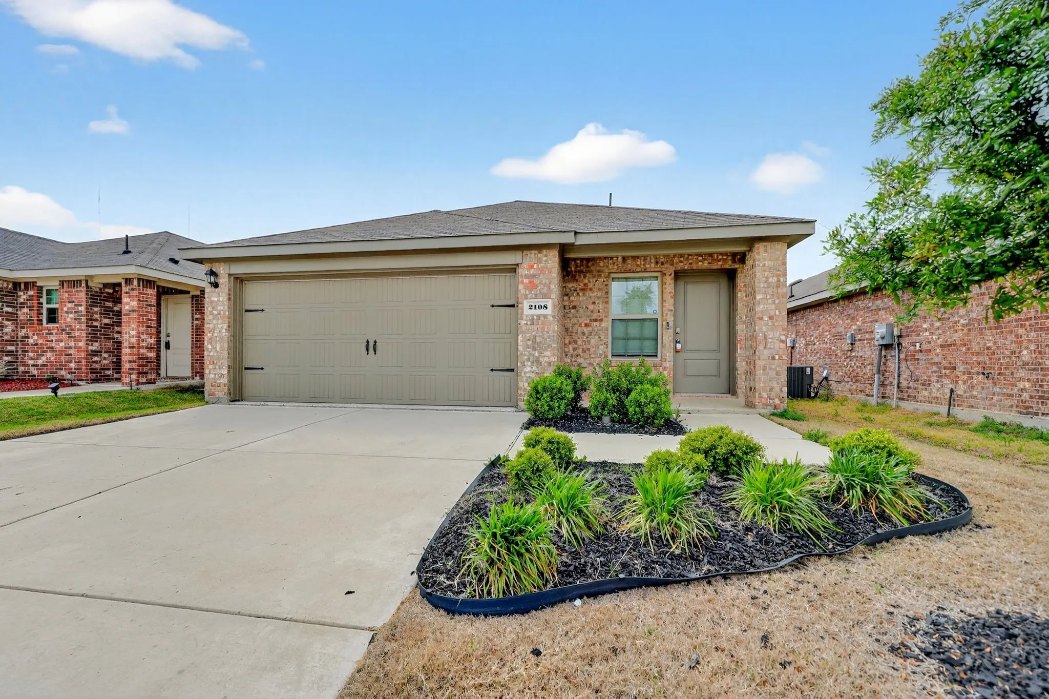 Brick exterior with a gabled roof and attached garage