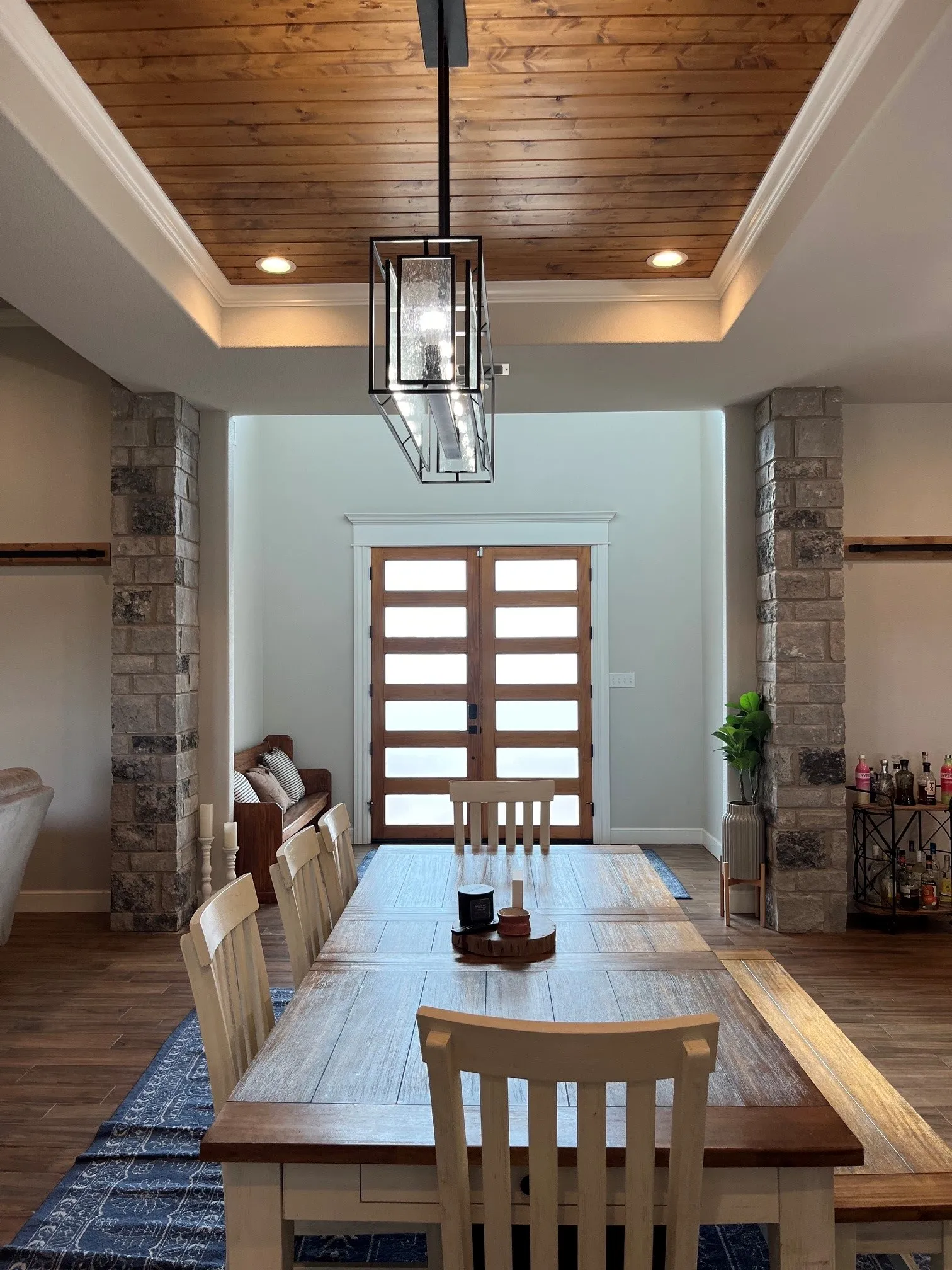 Recessed wood-panel ceiling with crown molding and integrated lighting