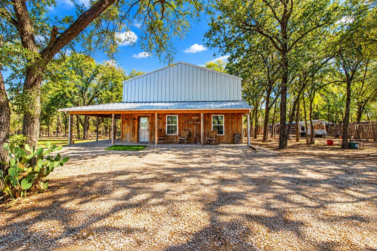 Wood-sided structure with a metal roof and an extended covered porch