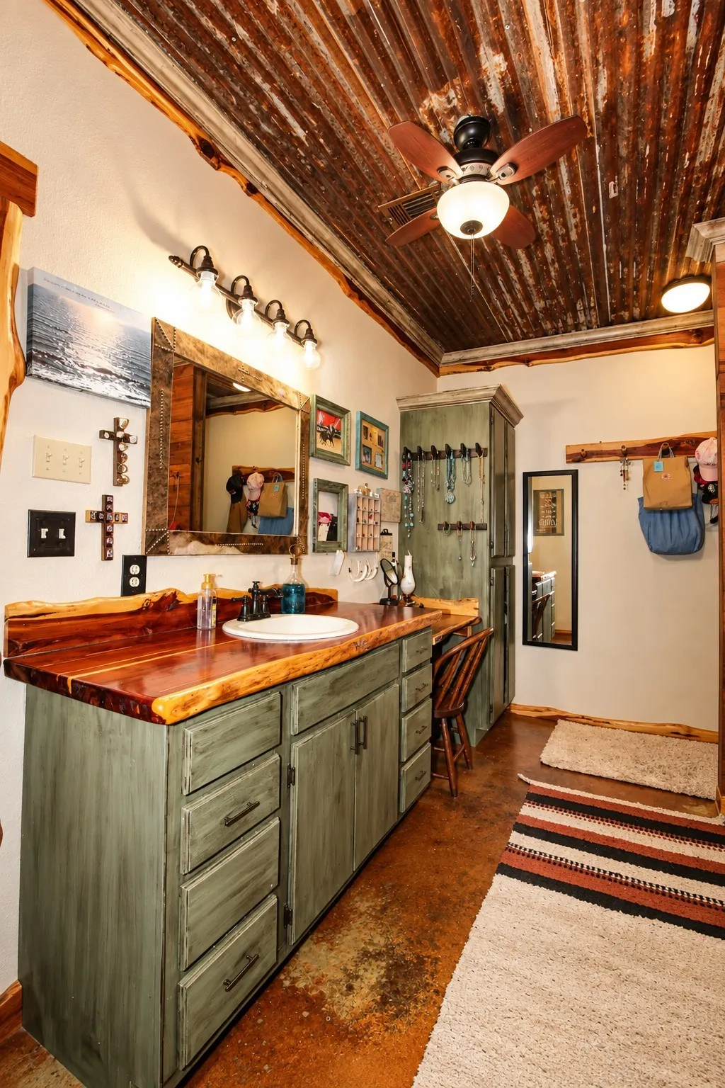 Vaulted ceiling with corrugated metal, wood-finish vanity with an integrated sink, natural wood countertop, decorative wall mirror, and ceiling fan with lighting