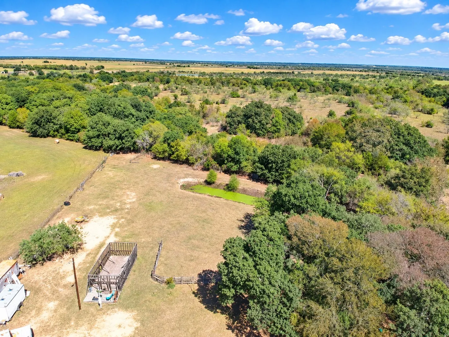 Expansive property featuring a mix of open land and mature tree coverage
