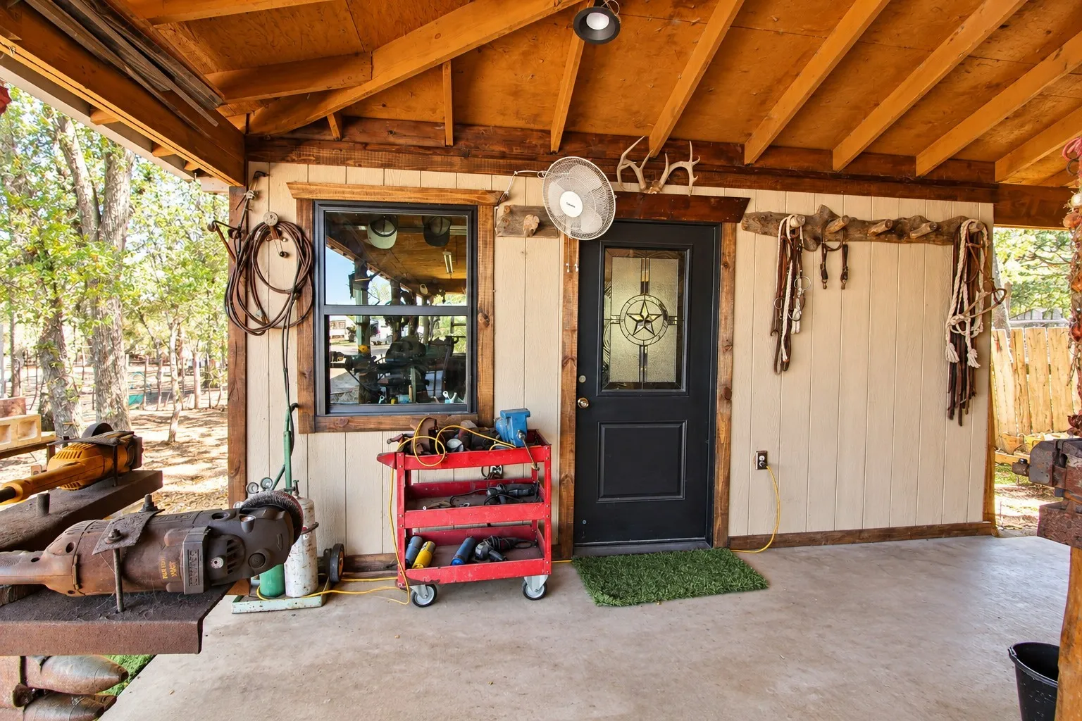 Covered concrete porch with exposed wood rafter ceiling