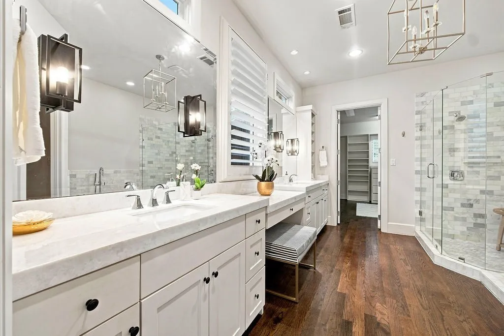 Dual vanities and a built-in makeup station give two people all the space they need to get ready without bumping elbows