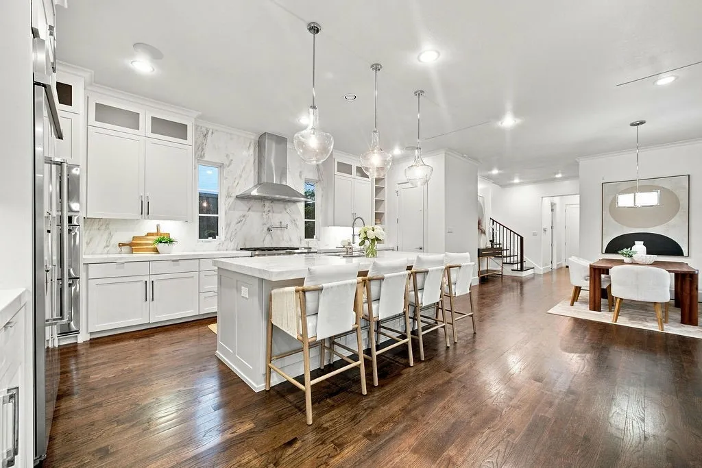 White cabinets run all the way to the ceiling, paired with quartz counters that give you endless workspace for holiday cooking