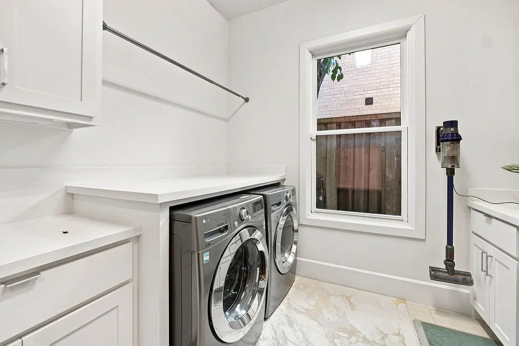 Plenty of upper cabinetry and expansive counter space take the hassle out of sorting and folding laundry