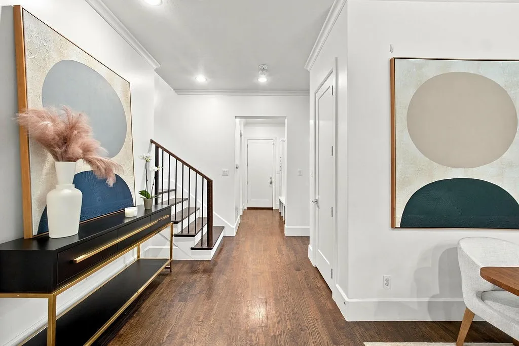 Clean architectural details, overhead accent lighting, and warm wood floors guide you through the downstairs living spaces