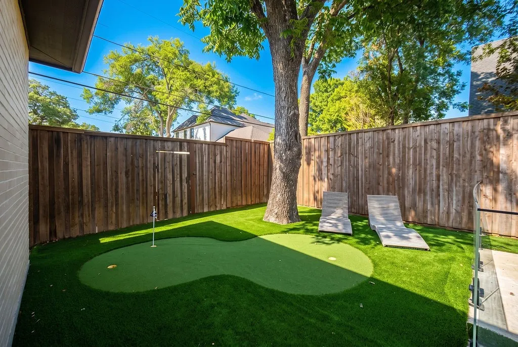 Work on your short game anytime on your private putting green, completing the fun outdoor setup of this Preston Hollow home