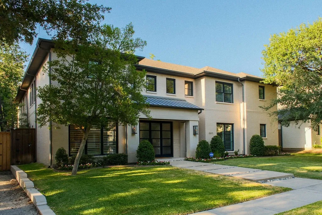 Multi-paned windows catch the light and hint at the bright, open living spaces waiting inside