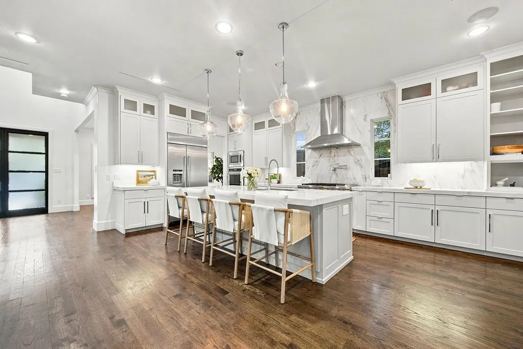 A quartz island sits at the middle of this room, giving you plenty of room to roll out dough, lay out party appetizers, or catch up over morning coffee