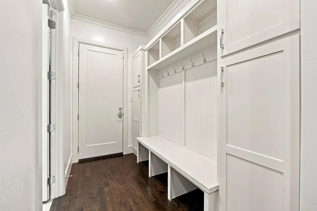 Built-in coat hooks, cubbies, and a sturdy bench keep backpacks, shoes, and coats organized right where you come in