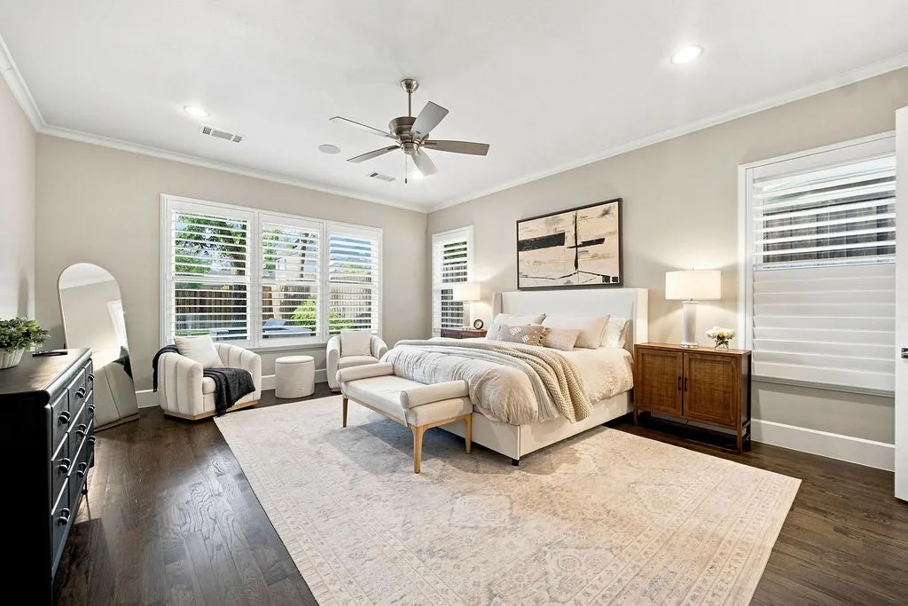 Located privately on the ground floor, this primary suite features wood shutters and soft neutrals for a restful night’s sleep