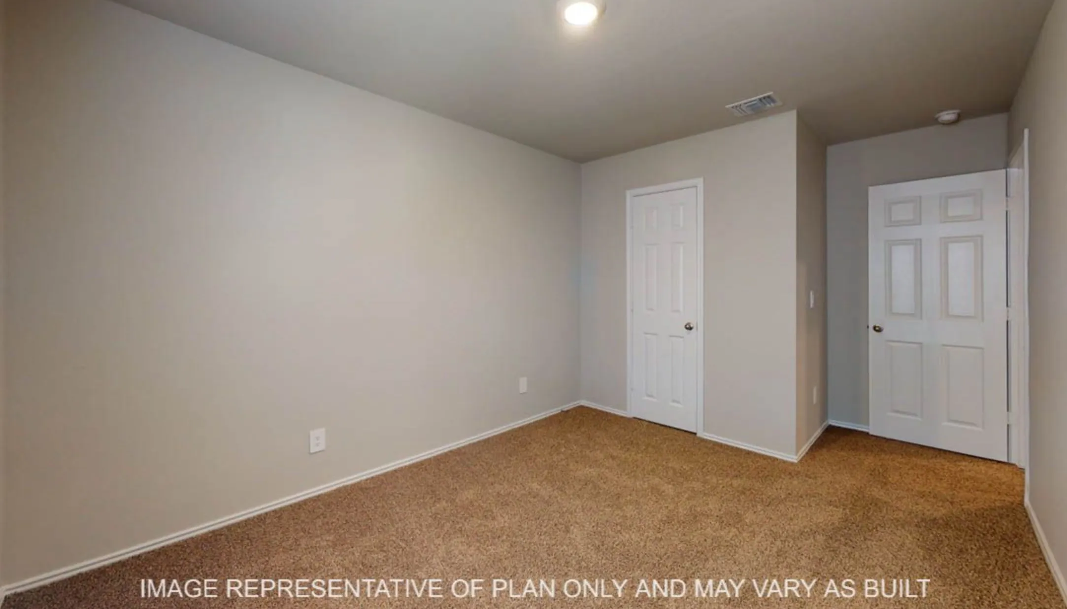 Neutral wall color with textured finish, carpeted flooring, and white trim