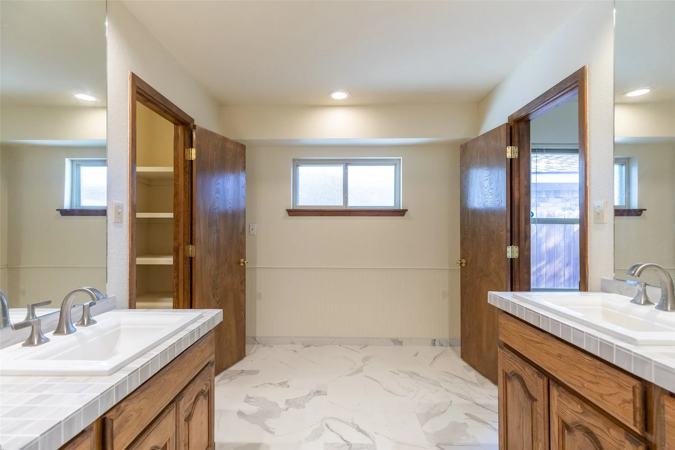 Dual vanities with tiled countertops and integrated sinks