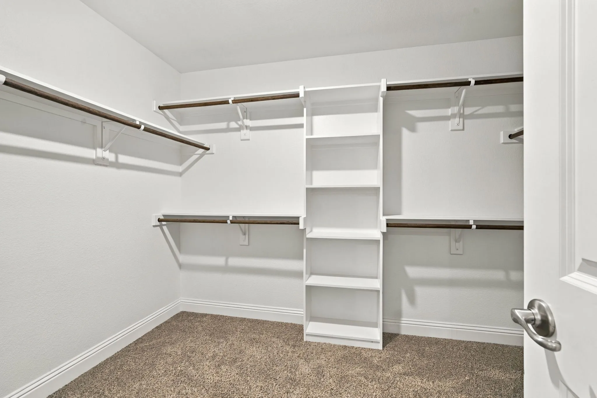 Integrated shelving unit, multiple hanging rods, and ample storage space