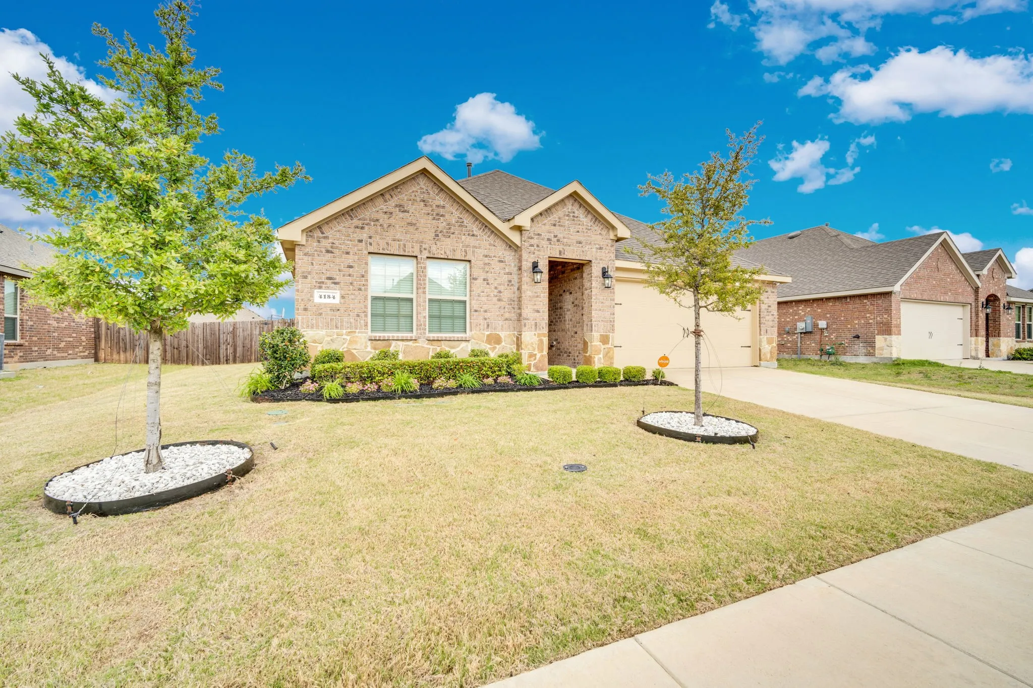 Brick exterior with stone accents and a two-car garage