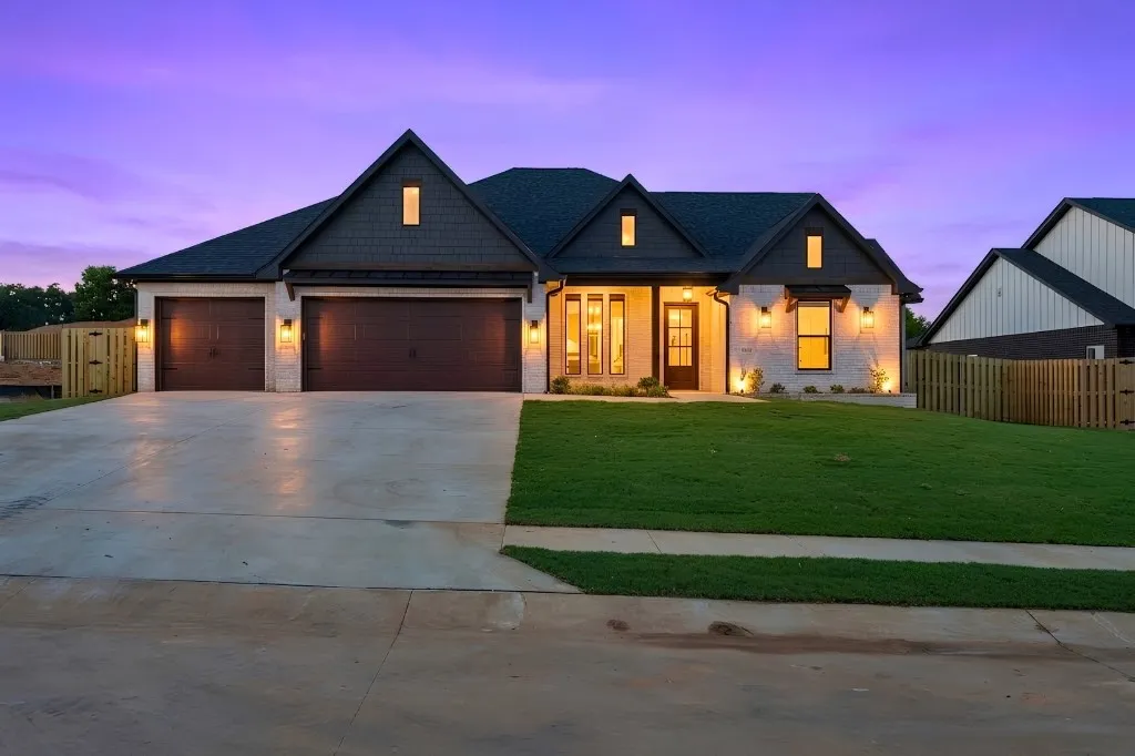 Modern farmhouse exterior with white brick and dark siding accents