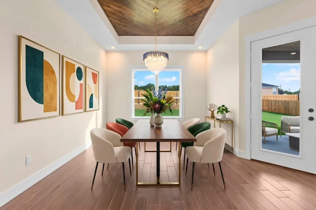 Wood-finish flooring throughout, tray ceiling with wood-finish inlay, and a chandelier with blue and gold accents