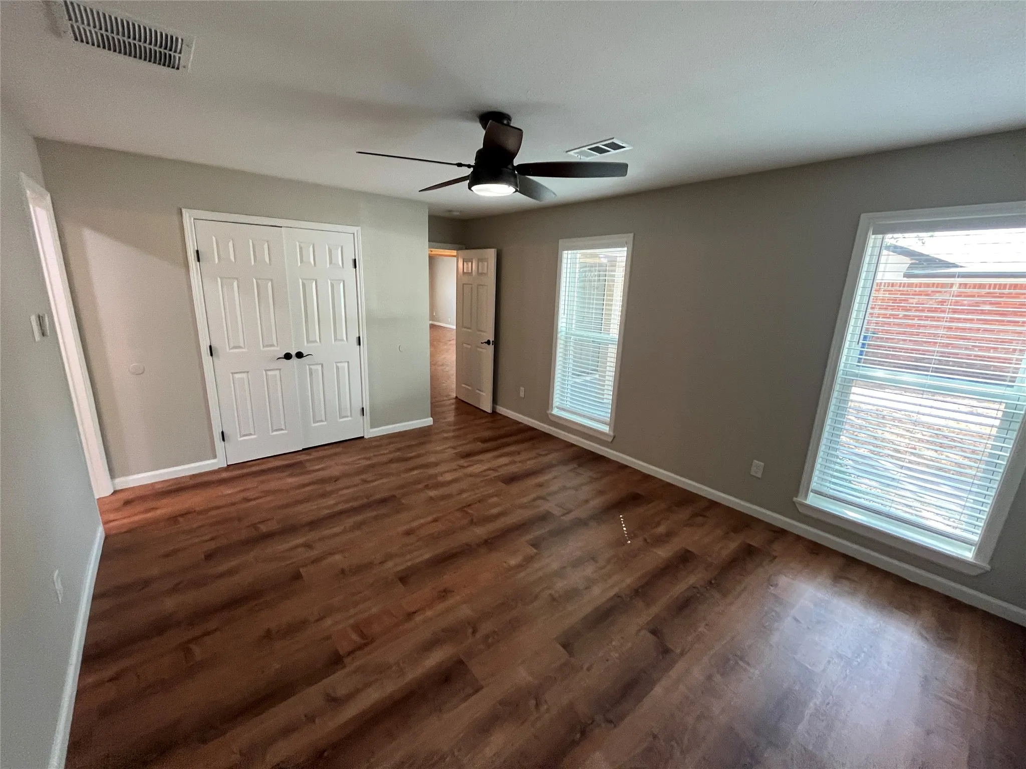 Wood-finish flooring, recessed lighting, and a ceiling fan