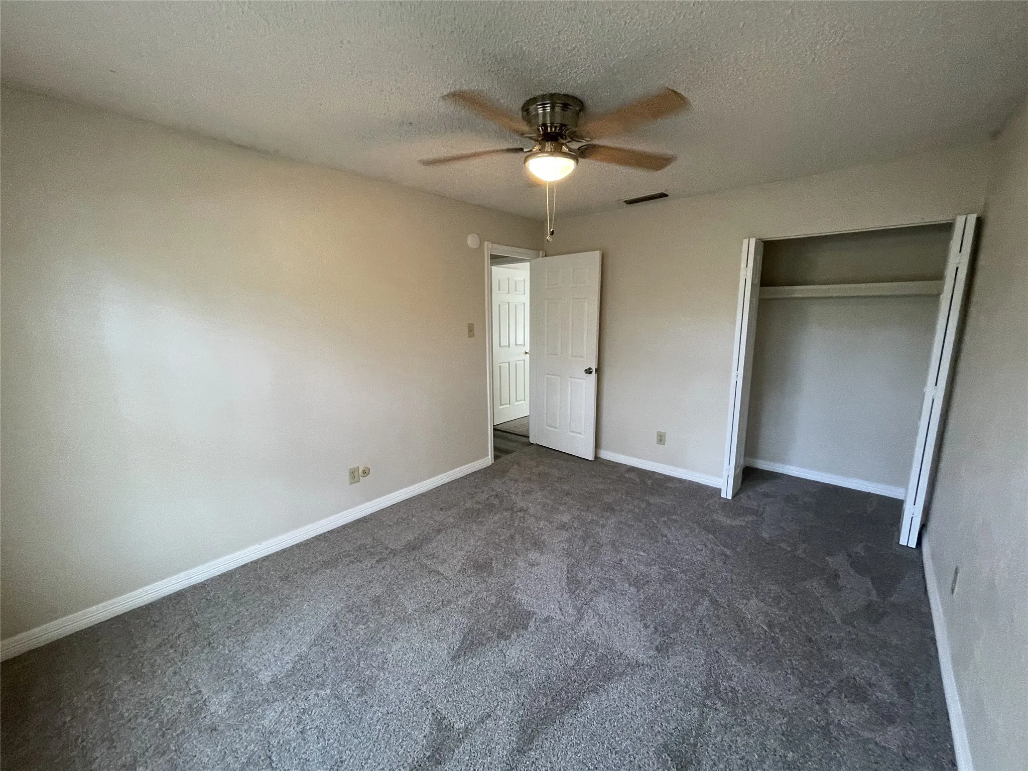 Neutral-toned walls complement the gray carpeting