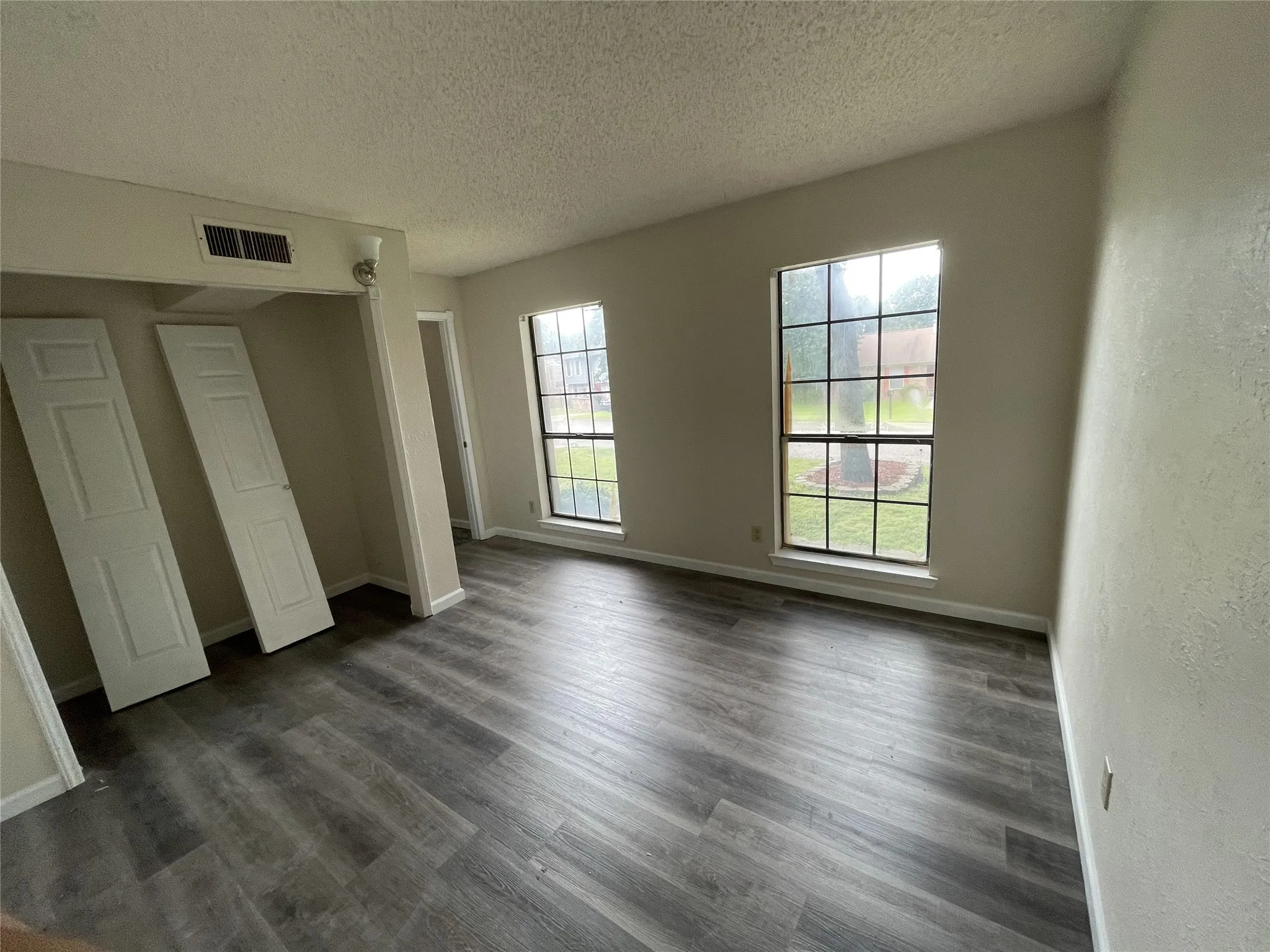 Wood-finish flooring, vaulted ceiling, and dual pane windows