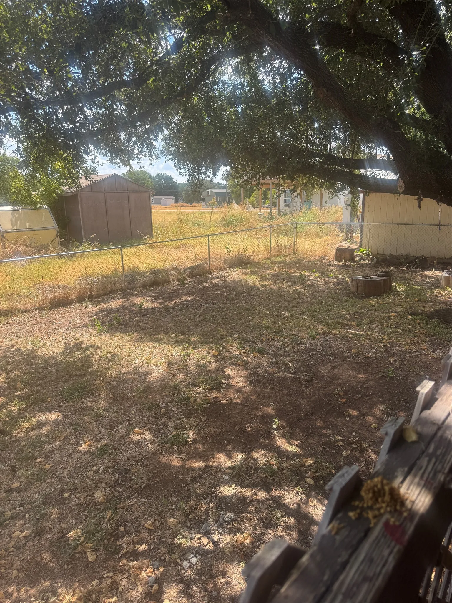 Fenced side yard with great shade tree