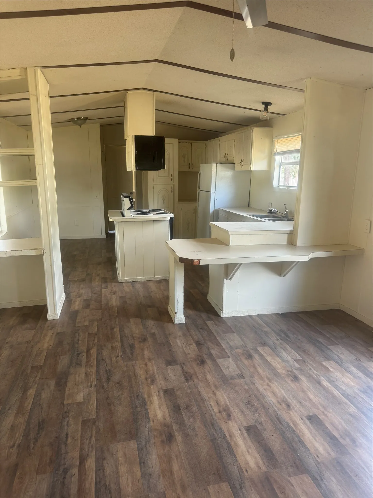 Newer vinyl plank flooring throughout, kitchen with a refrigerator
