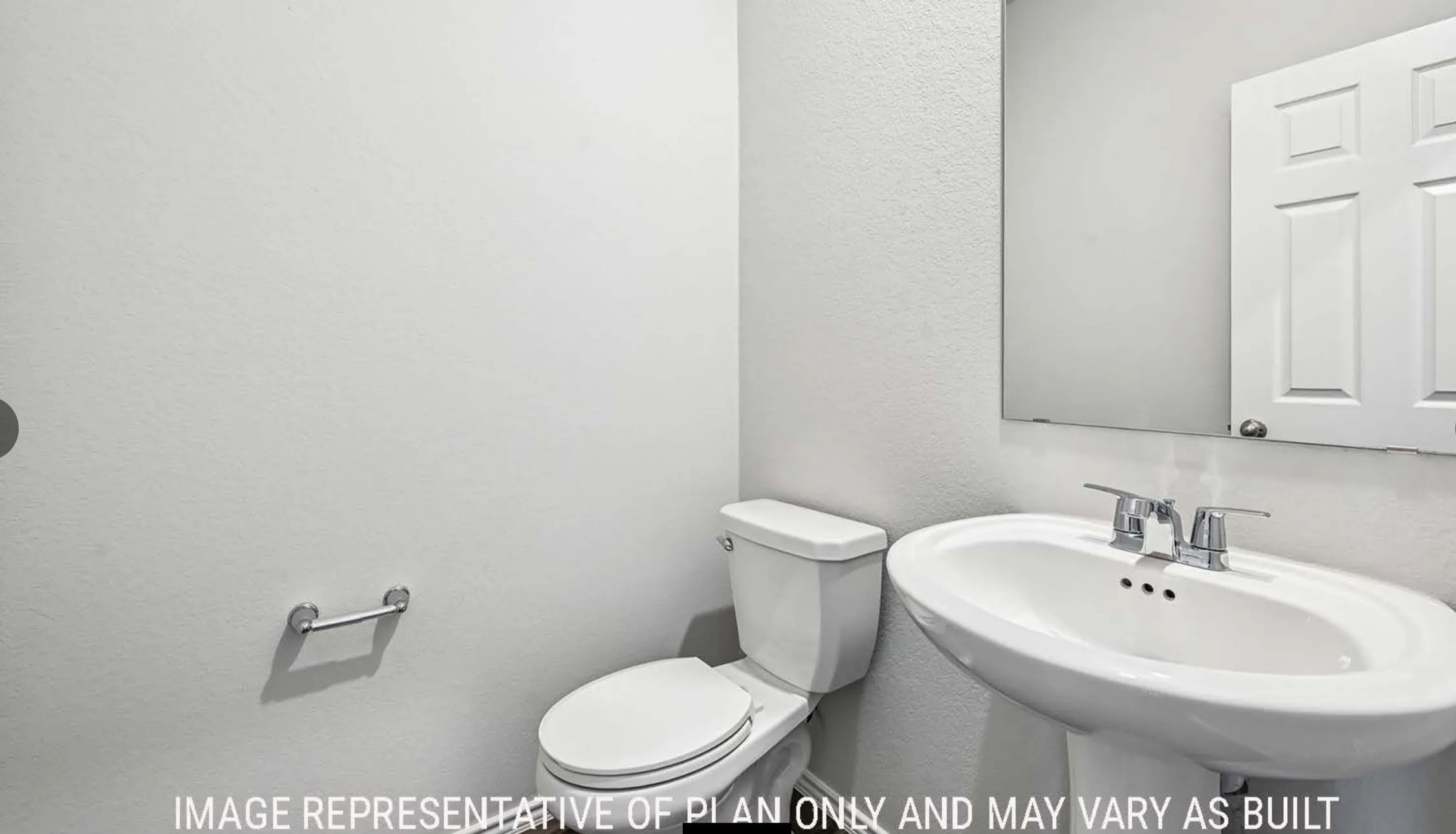 Pedestal sink with chrome fixtures and a rectangular wall mirror