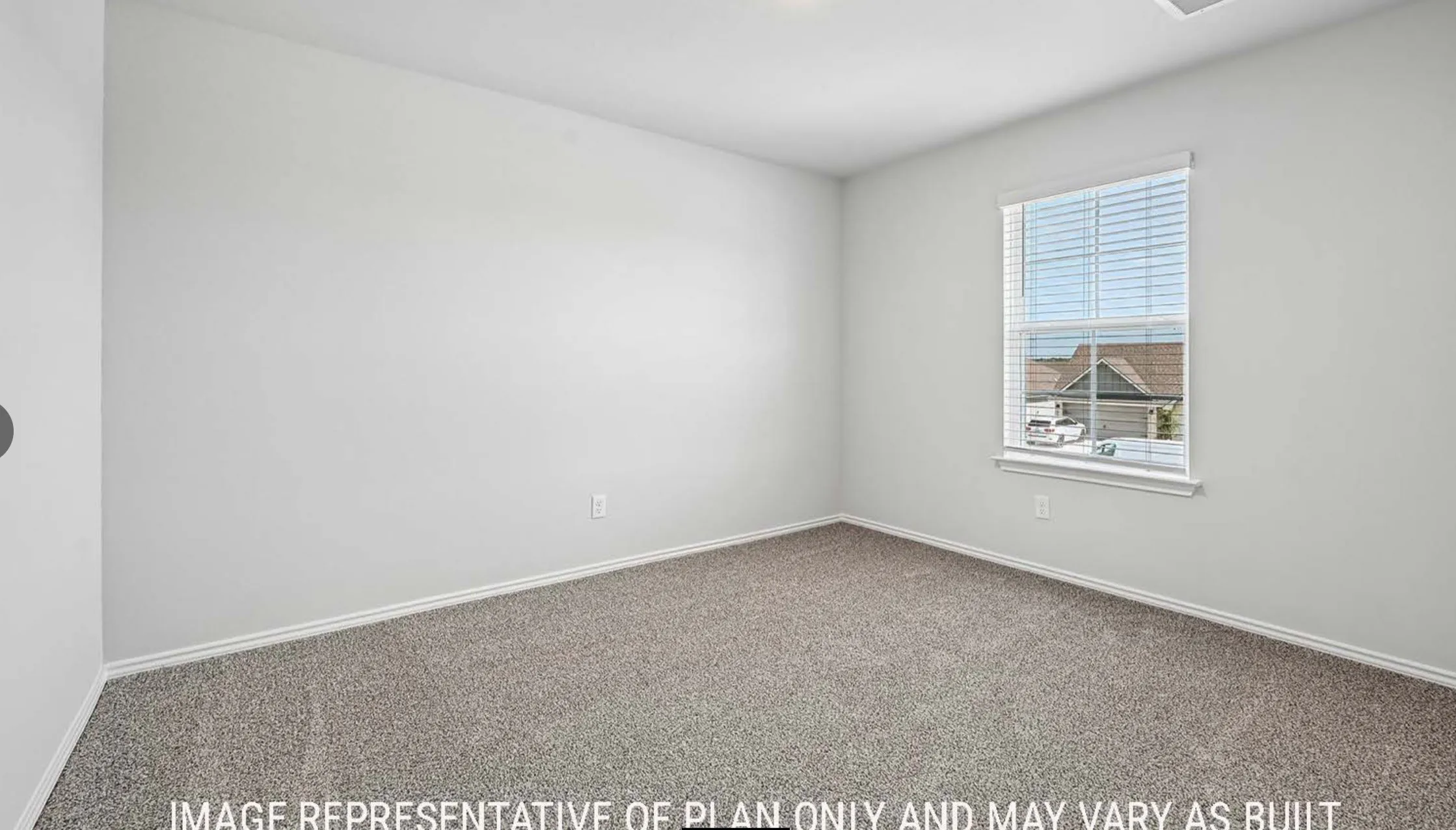 Carpeted flooring, neutral wall color, window with blinds, and white trim