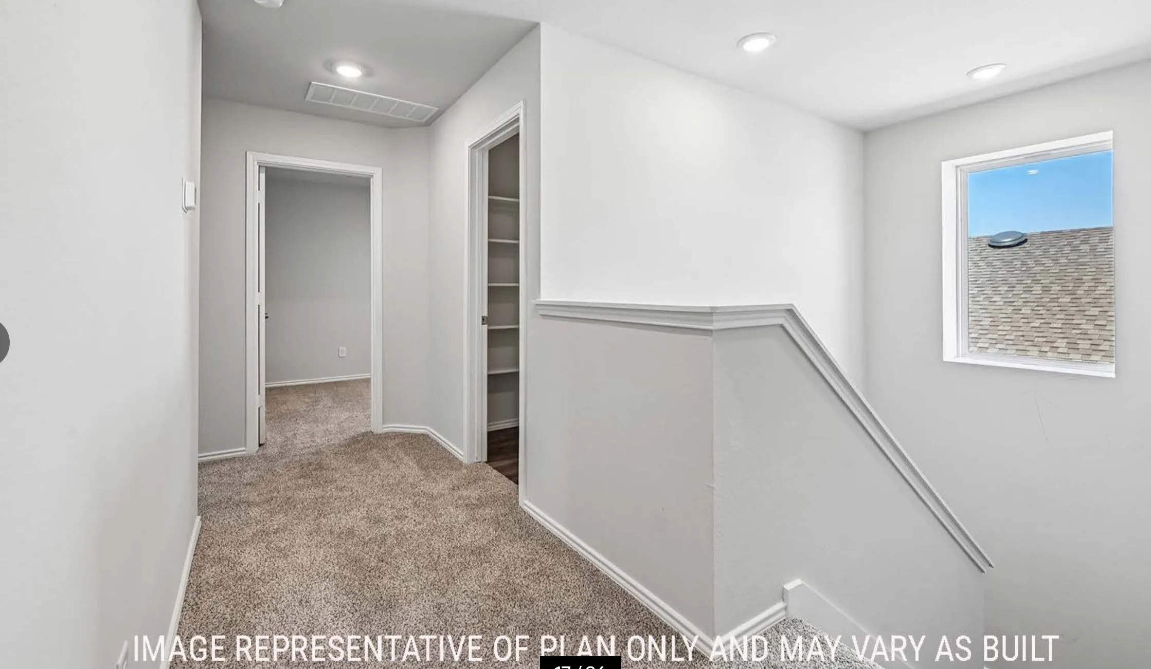 Carpeted hallway with a window, recessed lighting, and a built-in shelving unit