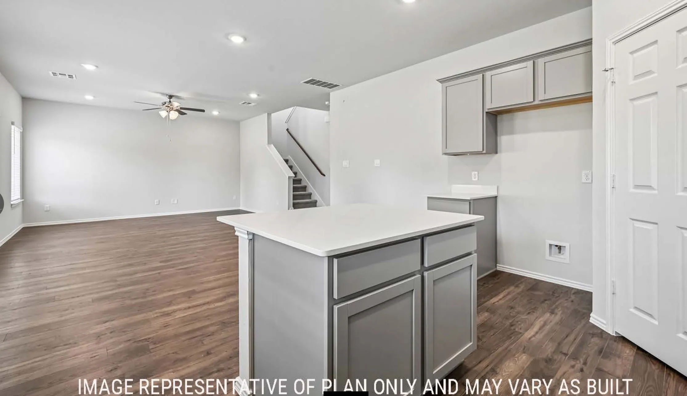 Spacious living area featuring wood-finish flooring, recessed lighting, and a ceiling fan