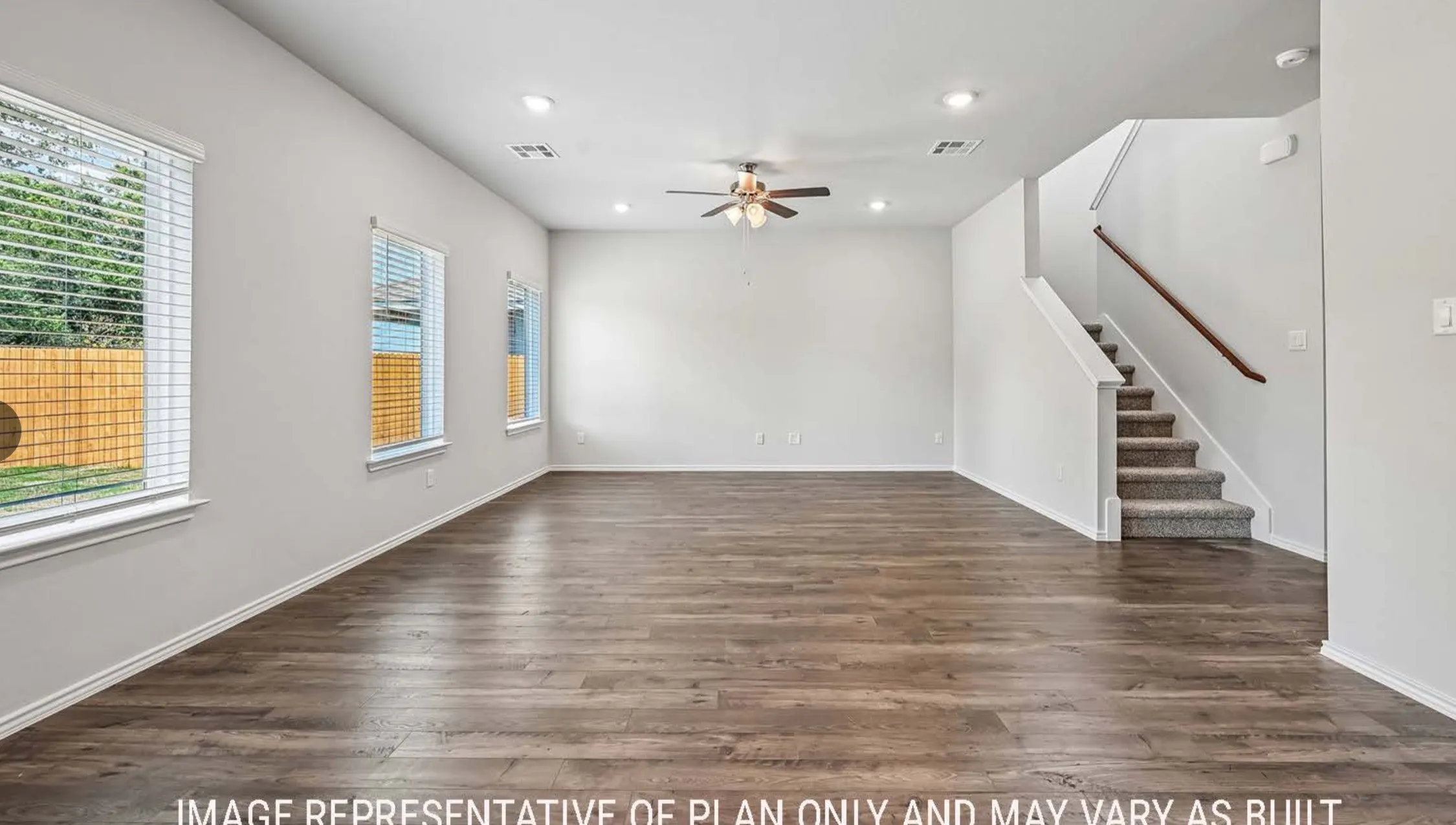 Spacious interior with wood-finish flooring, recessed lighting, and a ceiling fan