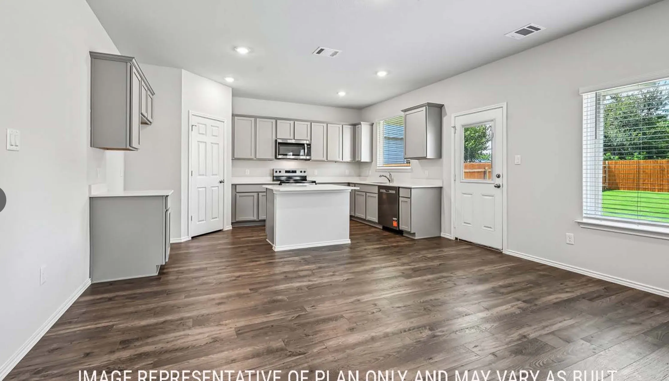 Open-concept kitchen and living area featuring wood-finish flooring, recessed lighting, and a kitchen island