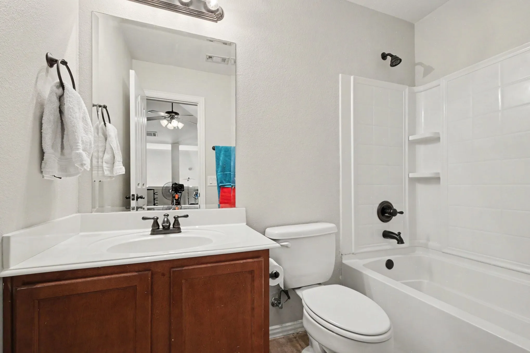 Bathroom 3 featuring a wood-finish vanity with an integrated sink and a white countertop