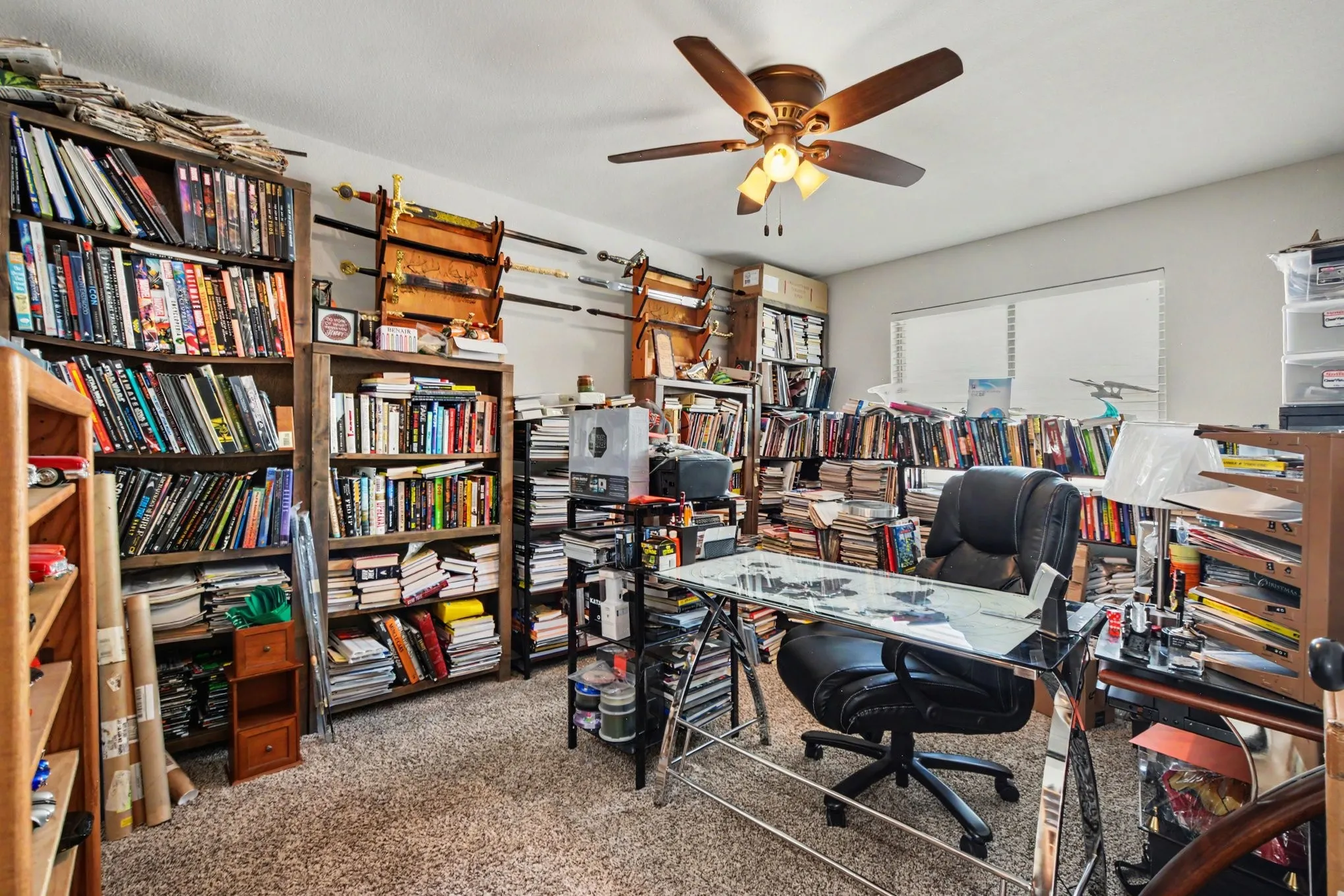 Recessed lighting, ceiling fan with integrated lighting, window with blinds, and built-in shelving