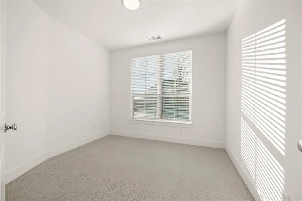 Recessed lighting, large window with blinds, light-colored carpeting, white wall finishes, and white trim