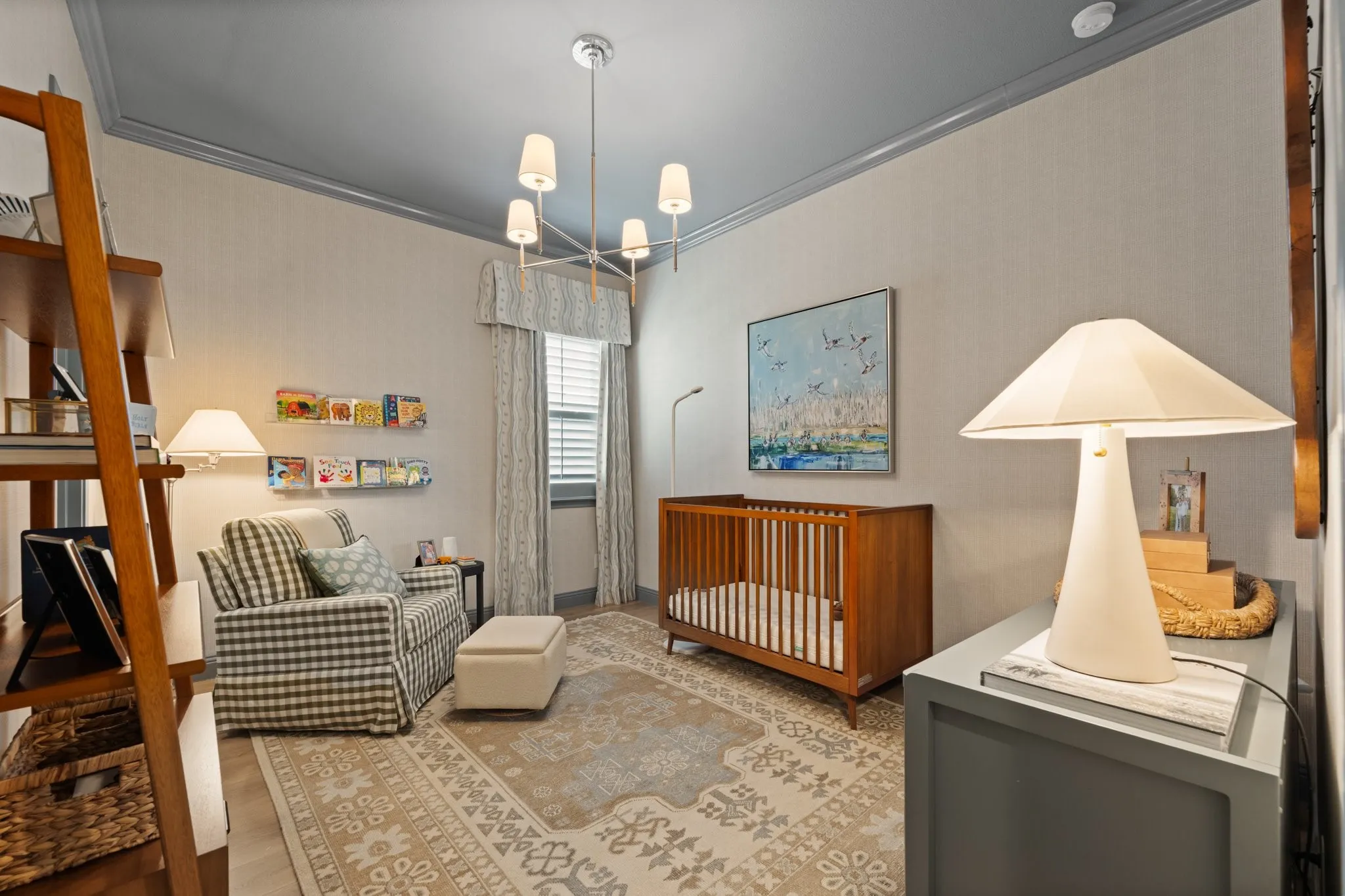 Secondary bedroom with plantation shutters, designer fixture and wallpaper