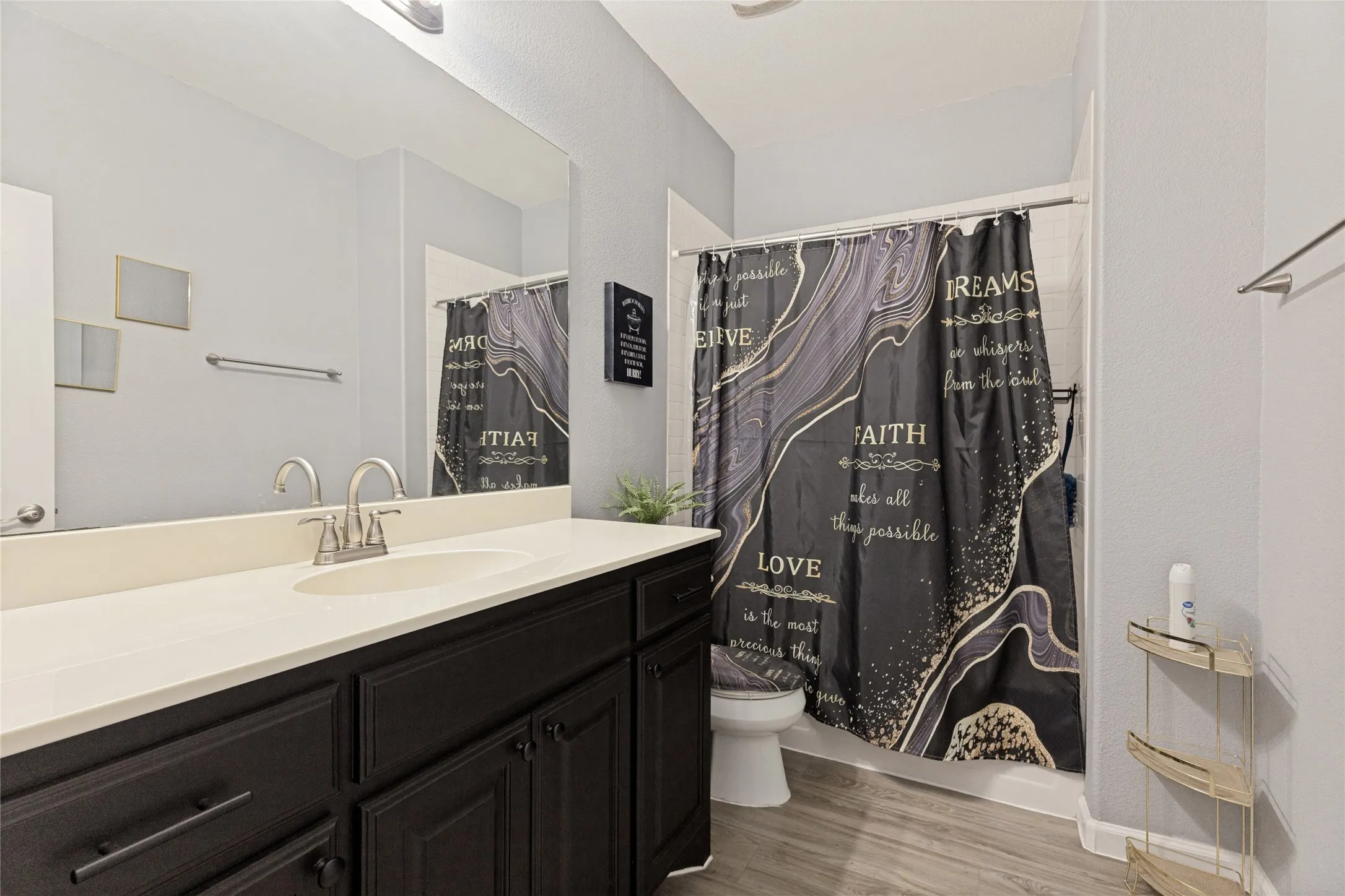 Dark wood-finish vanity with a white countertop and integrated sink
