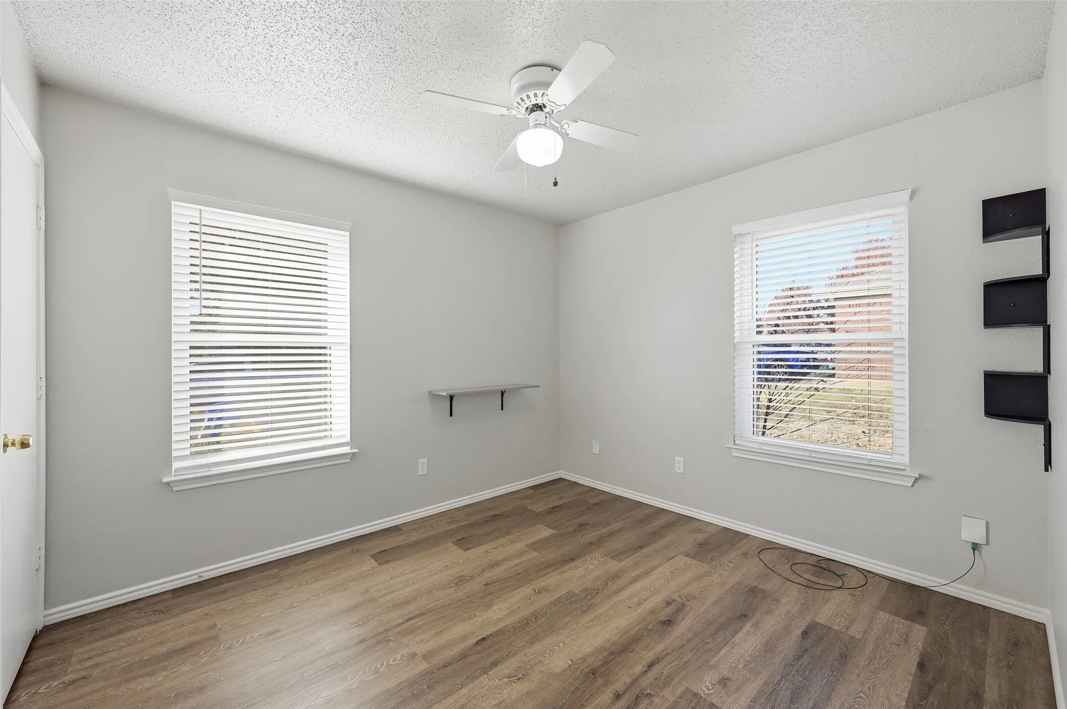 Wood-finish flooring with white baseboards