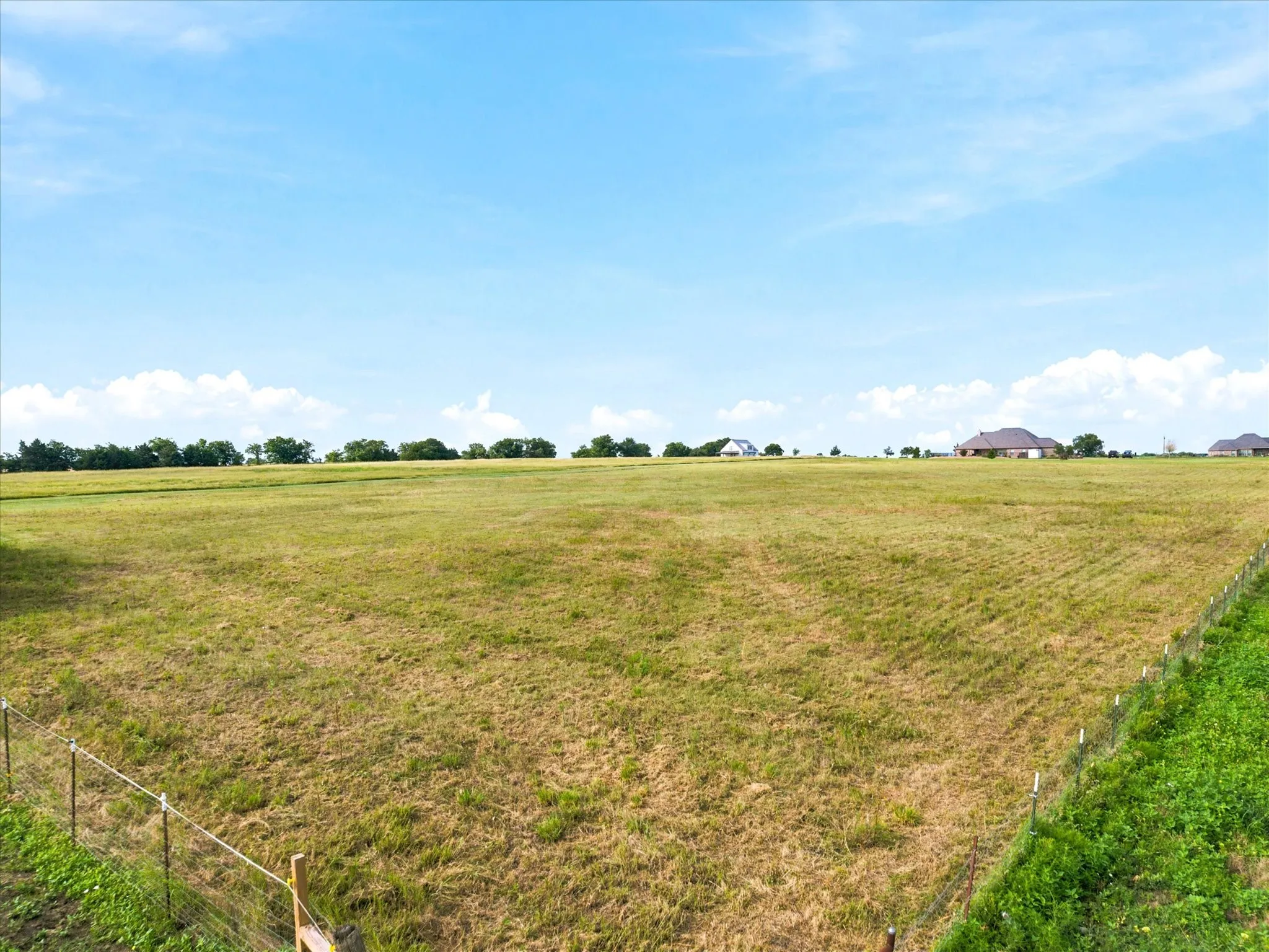 North East corner of subject. Partially fenced, and owned by neighbors