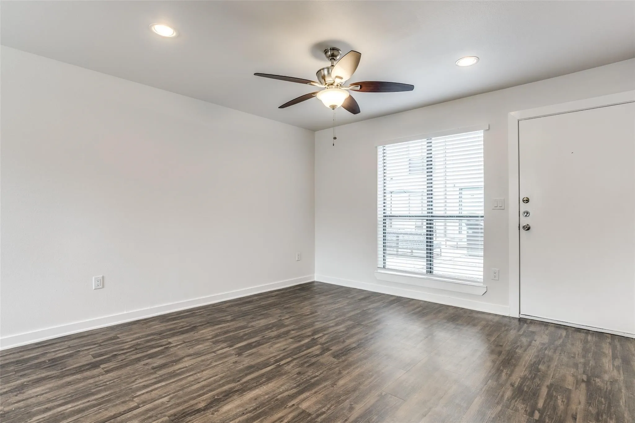 Wood-finish flooring with white baseboards