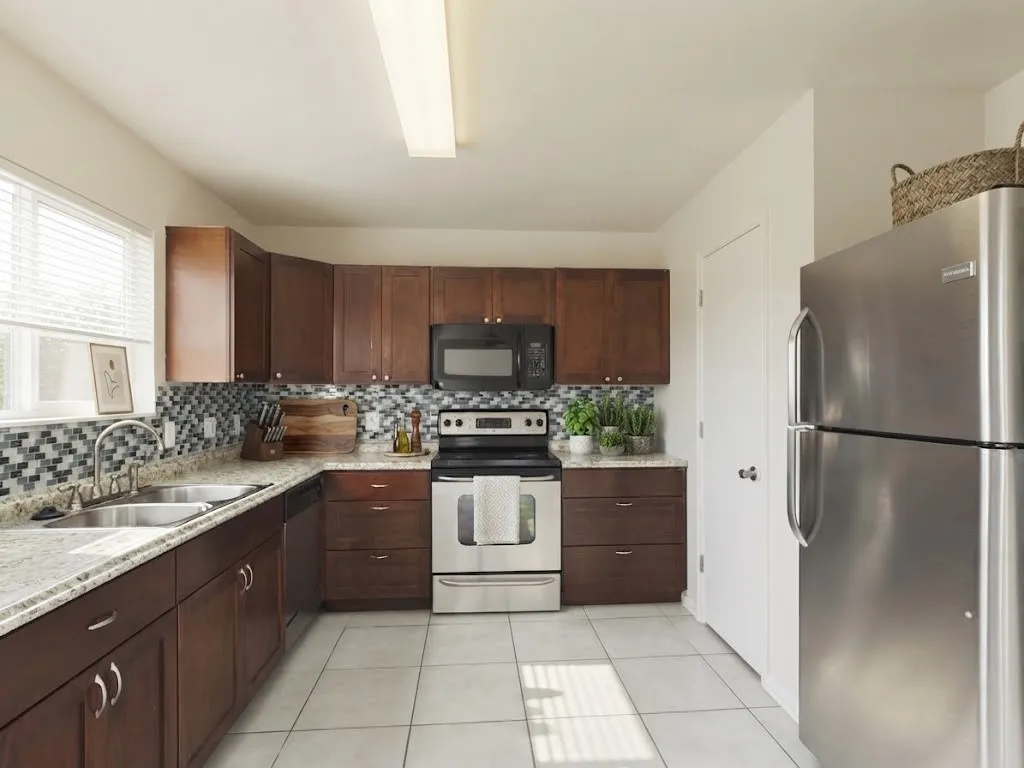 Kitchen featuring wood-finish cabinetry, stainless steel appliances, a mosaic tile backsplash, light-toned countertops, and tile flooring