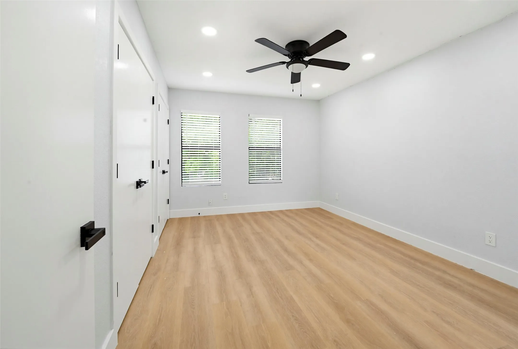 Wood-finish flooring, recessed lighting, and a ceiling fan with light